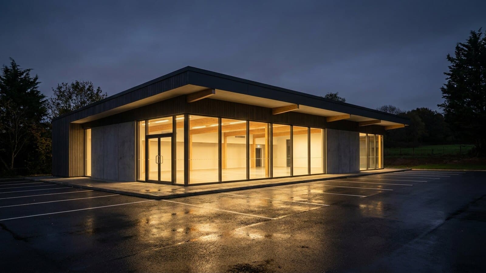 The exterior of a fitness facility lit from inside during the evening