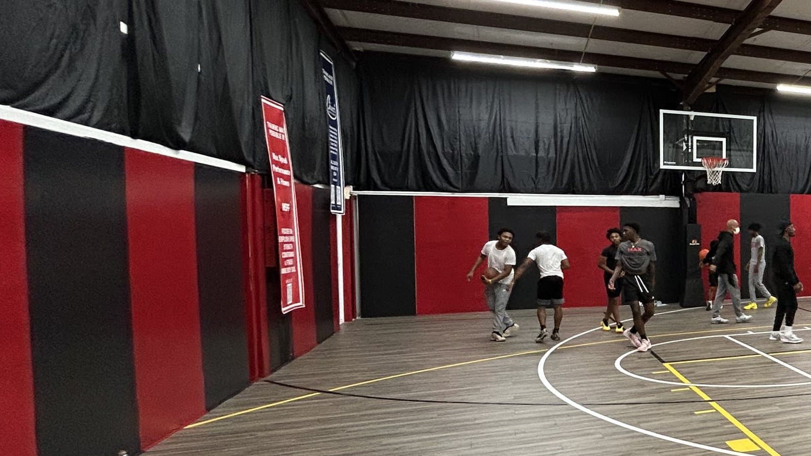 The red and black padded sideline of the indoor court at Max Speed Elite, a short drive from Blythewood, South Carolina